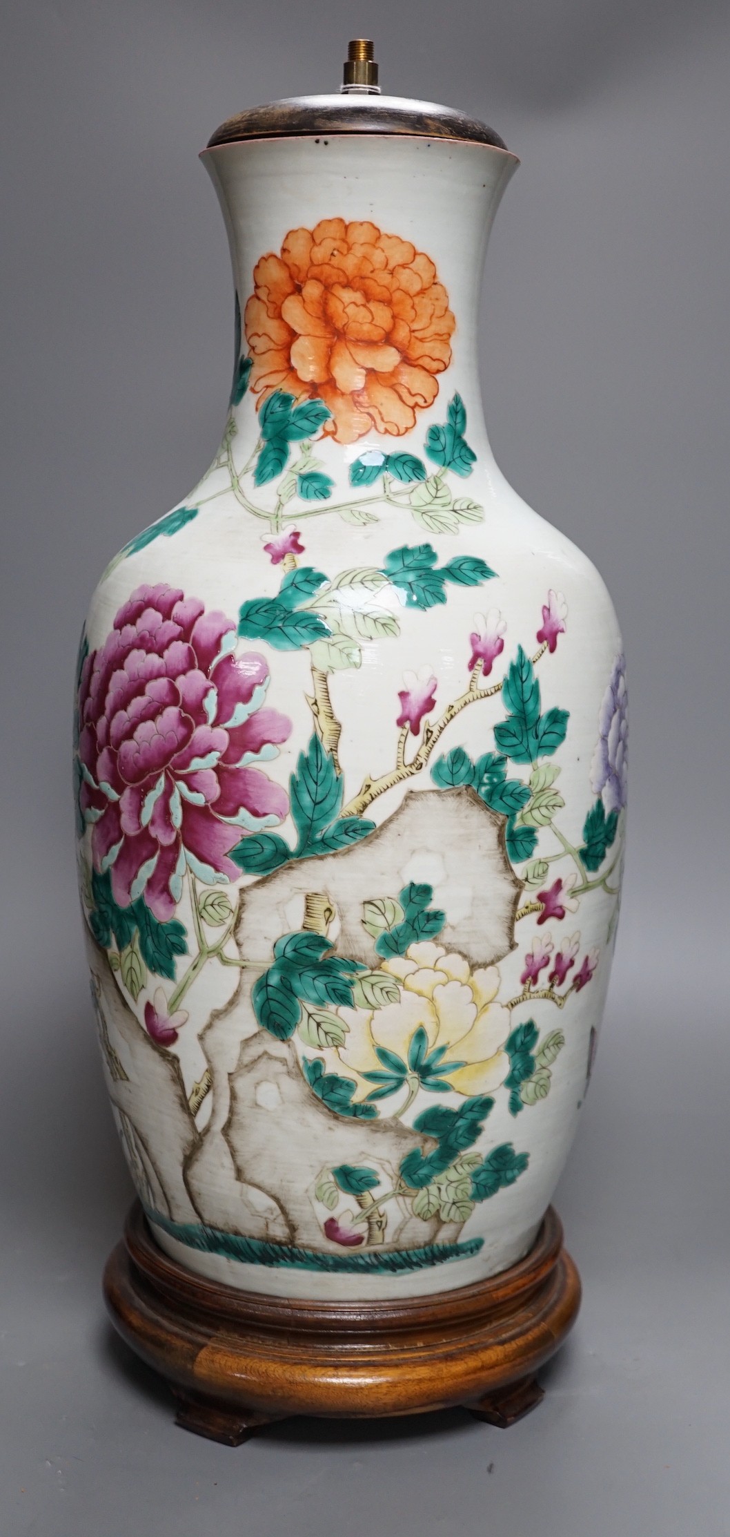 A large Chinese famille rose ‘peony and rockwork’ vase, converted into a lamp on wooden base, 53cm tall
